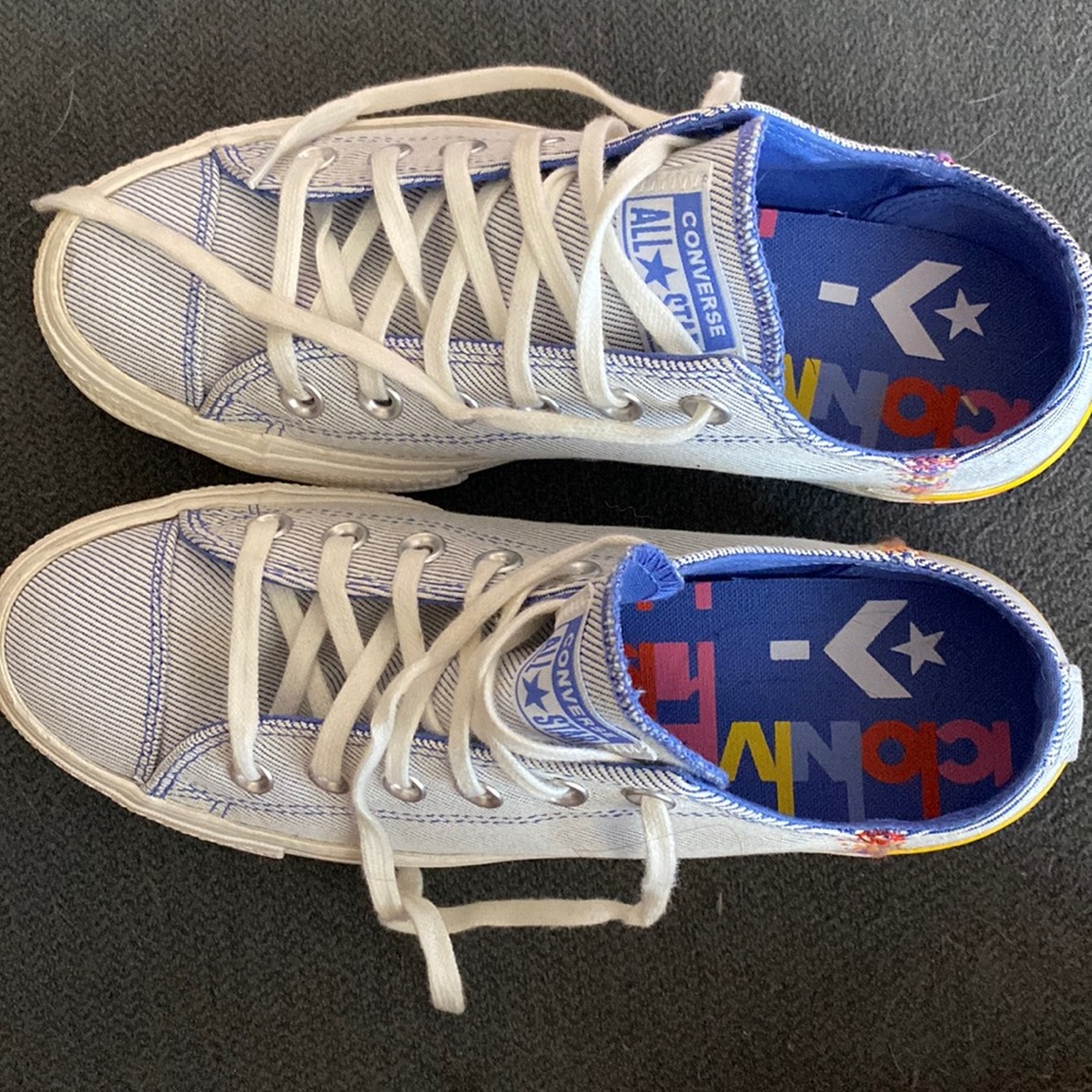 Blue and white striped converse with blue, pink, yellow stripe on the heel
